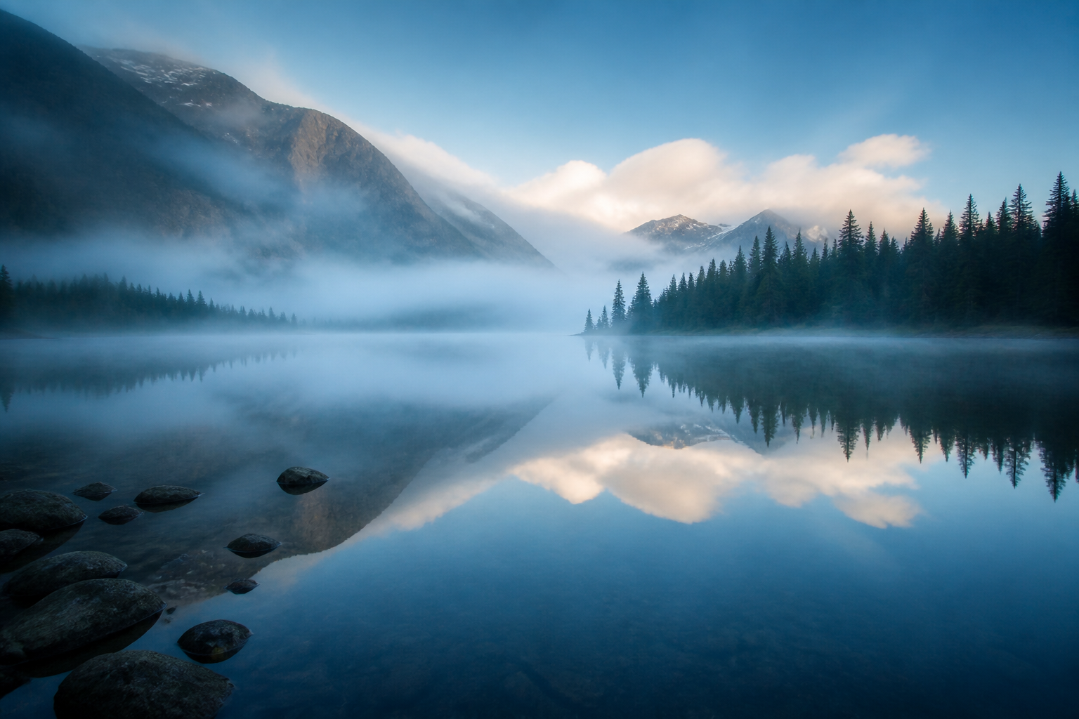 Misty mountain lake at dawn